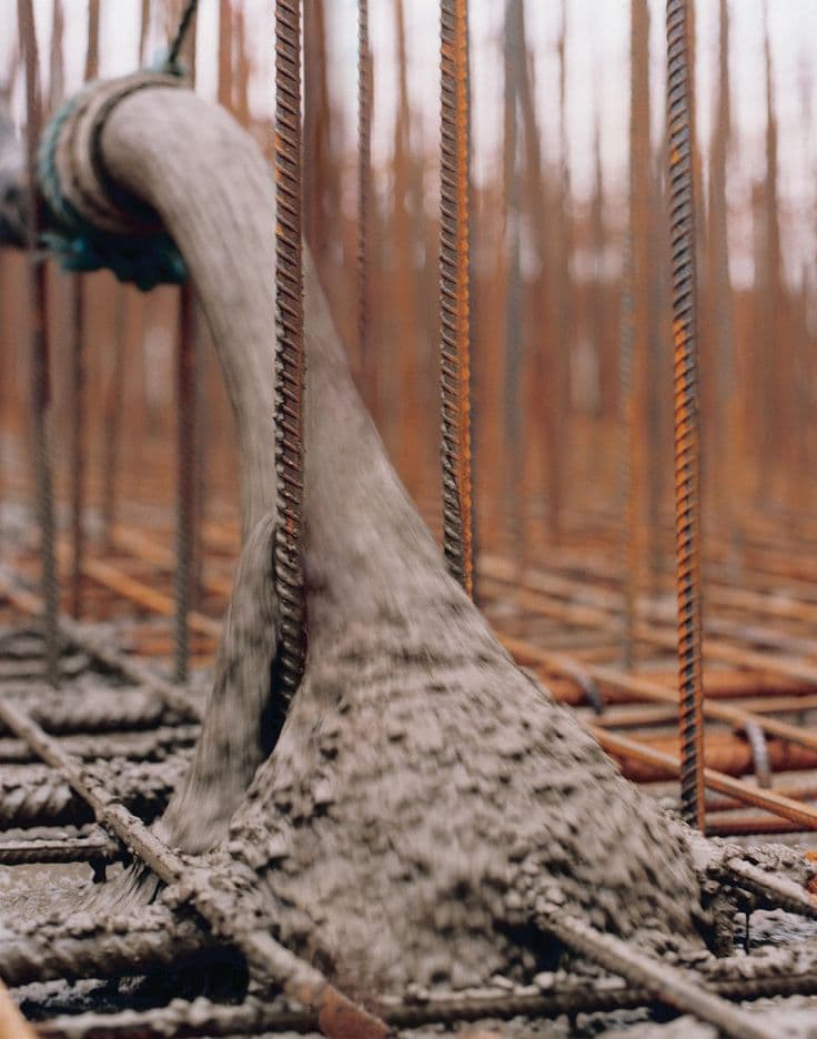 Concrete being placed over reinforcement on a civil works site